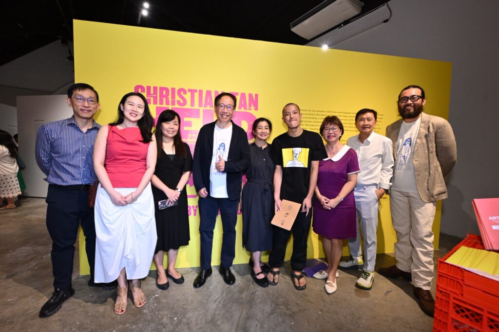 Artist Christian Tan (fourth from right) with Guest-of-Honour Ms Denise Phua, Mayor of Central Singapore District and MP for Jalan Besar GRC (third from right), UOL Group Chief Executive Liam Wee Sin (sixth from right), ART:DIS Chairman Andrew Liew (second from right), and representatives from UOL and ART:DIS at the launch of Christian’s debut solo exhibition “Held in the Middle” at Objectifs on 30 September 2026.